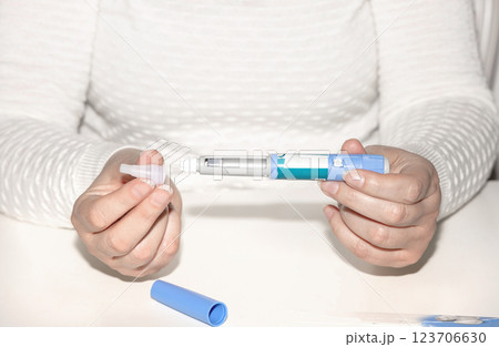 Female hands holding an insulin pen. Ozempic Insulin injection pen. 123706630