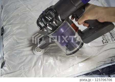 掃除機を使った布団圧縮の様子 掃除機を使った布団圧縮の様子 123706706