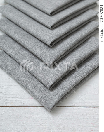 Grey napkins on a wooden white background. 123707821