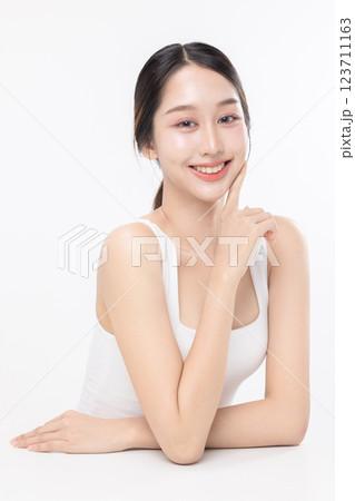 Close up facial of young Asian beautiful woman with K-beauty make up style and healthy and perfect glow skin with copyspace isolated on white background for skincare commercial product advertising. 123711163