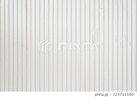 A white wavy wall with a copy space for your design. Decorative plaster on the wall. Uneven wall surface. High quality photo 123711180