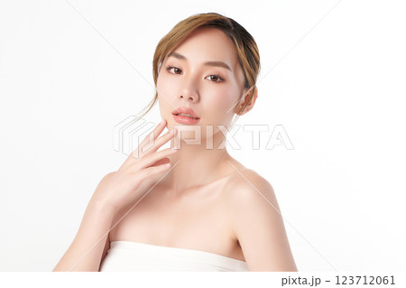 A beautiful young Asian woman with clean, fresh skin against a white background. She represents beauty, skincare, and spa treatments. A beautiful young Asian woman with clean, fresh skin against a white background. She represents beauty, skincare, and spa treatments. 123712061