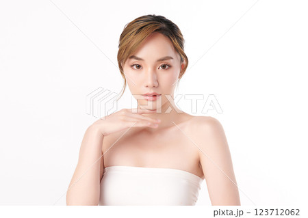 A beautiful young Asian woman with clean, fresh skin against a white background. She represents beauty, skincare, and spa treatments. 123712062
