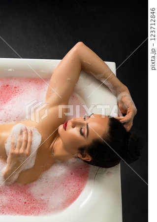 Relaxing in a pink bubble bath while enjoying personal time and tranquility 123712846