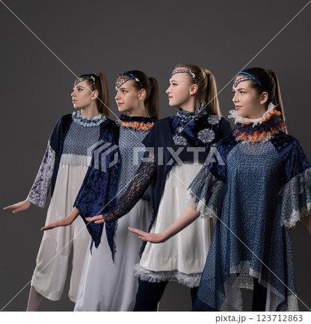 Dancers in elegant costumes performing a contemporary routine in studio 123712863