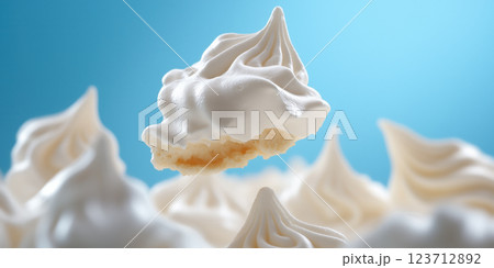 Meringue cookie with crisp texture and airy swirl against blue background 123712892