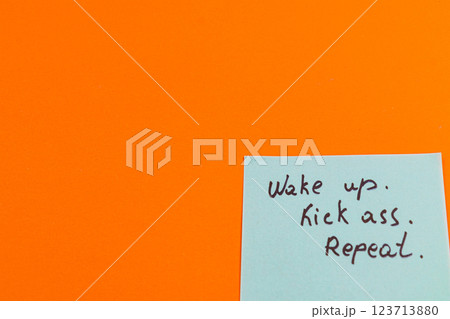 Motivational message on sticky note against vibrant orange background 123713880