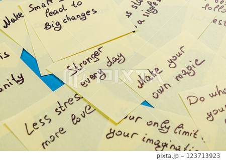 Motivational notes stacked on a table for personal growth and inspiration Motivational notes stacked on a table for personal growth and inspiration 123713923