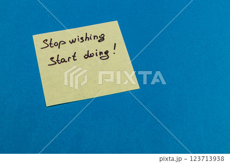 Motivational sticky note on blue background with a powerful message 123713938