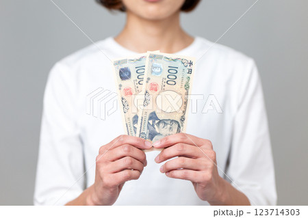 千円札を持つミドル女性 123714303