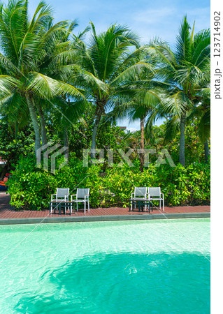 empty chair around swimming pool empty chair around swimming pool 123714902