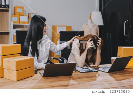 Startup SME small business entrepreneur of freelance Asian woman using a laptop with box Cheerful success Asian woman her hand lifts up online marketing packaging box and delivery SME idea concept Startup SME small business entrepreneur of freelance Asian woman using a laptop with box Cheerful success Asian woman her hand lifts up online marketing packaging box and delivery SME idea concept 123715039