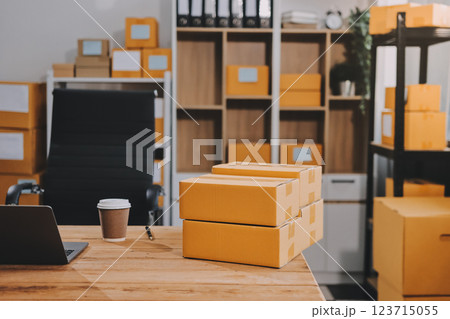 Asian SME business women use laptop computer checking customer order online shipping boxes at home. Starting Small business entrepreneur SME freelance. Online business, Work at home concept. Asian SME business women use laptop computer checking customer order online shipping boxes at home. Starting Small business entrepreneur SME freelance. Online business, Work at home concept. 123715055