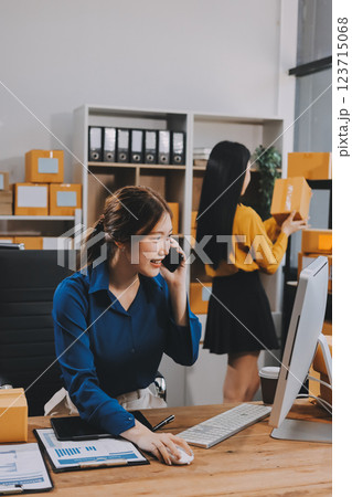 Asian SME business women use laptop computer checking customer order online shipping boxes at home. Starting Small business entrepreneur SME freelance. Online business, Work at home concept. 123715068