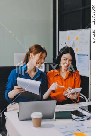 Entrepreneur Asian businessman and businesswoman discussing new business project in tablet in modern Meeting In Modern Office, Asian business casual concept. Entrepreneur Asian businessman and businesswoman discussing new business project in tablet in modern Meeting In Modern Office, Asian business casual concept. 123715084