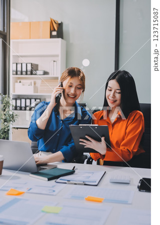 Entrepreneur Asian businessman and businesswoman discussing new business project in tablet in modern Meeting In Modern Office, Asian business casual concept. 123715087