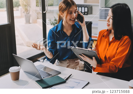 Entrepreneur Asian businessman and businesswoman discussing new business project in tablet in modern Meeting In Modern Office, Asian business casual concept. Entrepreneur Asian businessman and businesswoman discussing new business project in tablet in modern Meeting In Modern Office, Asian business casual concept. 123715088