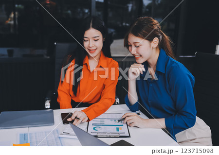 Entrepreneur Asian businessman and businesswoman discussing new business project in tablet in modern Meeting In Modern Office, Asian business casual concept. 123715098