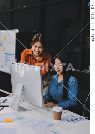 Entrepreneur Asian businessman and businesswoman discussing new business project in tablet in modern Meeting In Modern Office, Asian business casual concept. 123715107