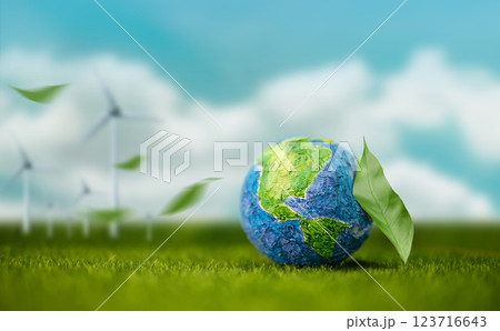 World Earth Day Concept. Green Energy, Renewable and Sustainable Resources. Environmental and Ecology. Green Leaf by the Globe.Blue Sky and Wind Turbine Generator as background World Earth Day Concept. Green Energy, Renewable and Sustainable Resources. Environmental and Ecology. Green Leaf by the Globe.Blue Sky and Wind Turbine Generator as background 123716643