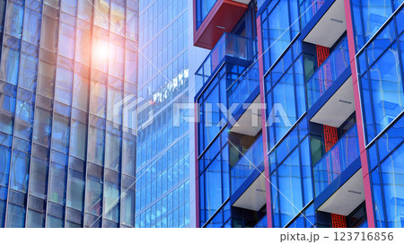 View of an modern apartment building standing next to a new modern office building with a glass facade. View of an modern apartment building standing next to a new modern office building with a glass facade. 123716856