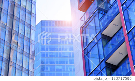 View of an modern apartment building standing next to a new modern office building with a glass facade. 123717596