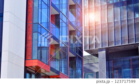 View of an modern apartment building standing next to a new modern office building with a glass facade. 123717599