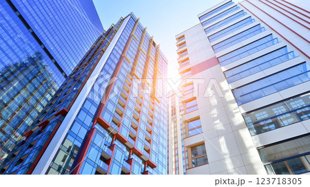 View of an modern apartment building standing next to a new modern office building with a glass facade. 123718305