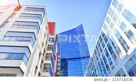 View of an modern apartment building standing next to a new modern office building with a glass facade. 123718316