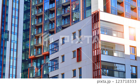 View of an modern apartment building standing next to a new modern office building with a glass facade. 123718333