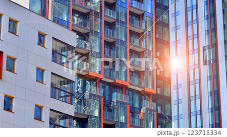 View of an modern apartment building standing next to a new modern office building with a glass facade. 123718334