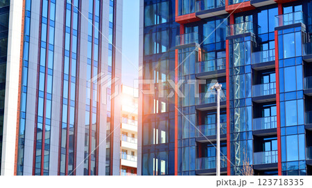 View of an modern apartment building standing next to a new modern office building with a glass facade. 123718335