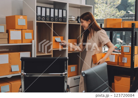 Asian SME business women use laptop computer checking customer order online shipping boxes at home. Starting Small business entrepreneur SME freelance. Online business, Work at home concept. 123720084