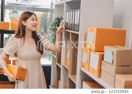 Asian SME business women use laptop computer checking customer order online shipping boxes at home. Starting Small business entrepreneur SME freelance. Online business, Work at home concept. 123720085