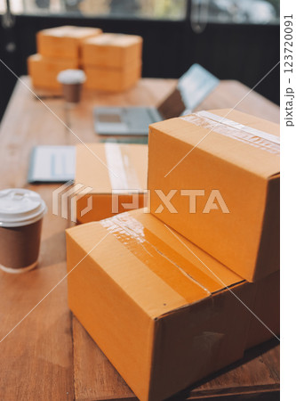 Asian SME business women use laptop computer checking customer order online shipping boxes at home. Starting Small business entrepreneur SME freelance. Online business, Work at home concept. Asian SME business women use laptop computer checking customer order online shipping boxes at home. Starting Small business entrepreneur SME freelance. Online business, Work at home concept. 123720091