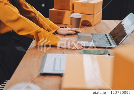 Asian SME business women use laptop computer checking customer order online shipping boxes at home. Starting Small business entrepreneur SME freelance. Online business, Work at home concept. 123720093