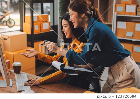 Asian SME business women use laptop computer checking customer order online shipping boxes at home. Starting Small business entrepreneur SME freelance. Online business, Work at home concept. 123720094