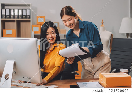 Asian SME business women use laptop computer checking customer order online shipping boxes at home. Starting Small business entrepreneur SME freelance. Online business, Work at home concept. Asian SME business women use laptop computer checking customer order online shipping boxes at home. Starting Small business entrepreneur SME freelance. Online business, Work at home concept. 123720095