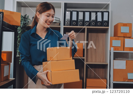 Asian SME business women use laptop computer checking customer order online shipping boxes at home. Starting Small business entrepreneur SME freelance. Online business, Work at home concept. 123720110