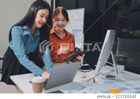 Entrepreneur Asian businessman and businesswoman discussing new business project in tablet in modern Meeting In Modern Office, Asian business casual concept. 123720142