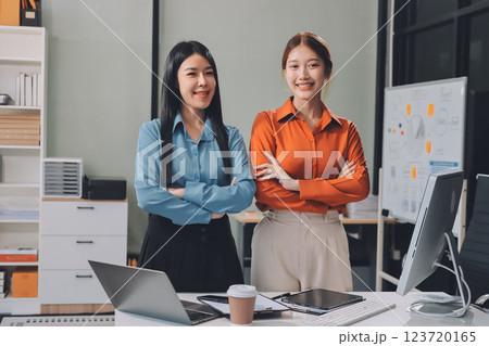 Portrait happy two young asian businesswoman standing with confident together in office, happiness two business woman arms crossed with success, coworker and friendship, business and team. 123720165