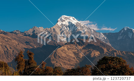 Annapurna South majestic peak under morning sunlight with blue sky 123720737
