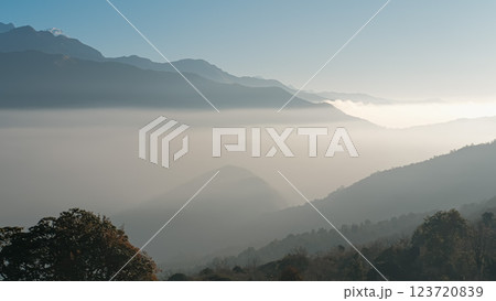 Morning sunlight highlights the majestic hills of Annapurna region, foggy magical morning 123720839