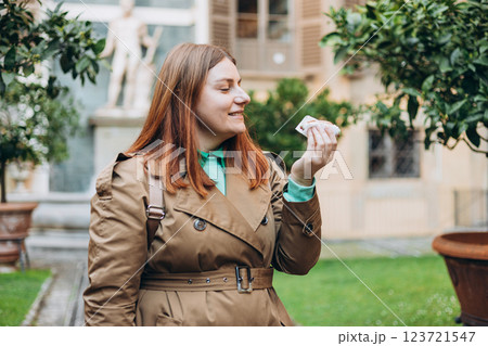 Happy 30s woman holding Sicilian cannolo tube pastry filled with cream outdoors. Travel, Italy, food and holidays concept. Young woman eating traditional delicious cake cannoli, Traveling Europe Happy 30s woman holding Sicilian cannolo tube pastry filled with cream outdoors. Travel, Italy, food and holidays concept. Young woman eating traditional delicious cake cannoli, Traveling Europe 123721547