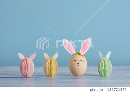 Easter bunny eggs on pastel blue background. Place for your text, wishes, congratulations. Easter bunny eggs on pastel blue background. Place for your text, wishes, congratulations. 123721573
