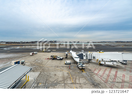 Small commercial aircraft parking at the gate with jetbridge connecting to it for passengers to exit 123721647