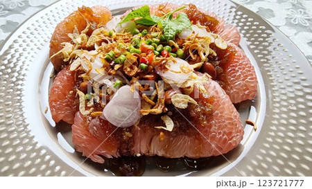 Pomelo with sweet fish sauce. Thai food. Refreshing Citrus Salad with Garnishes and Herbs on Plate 123721777