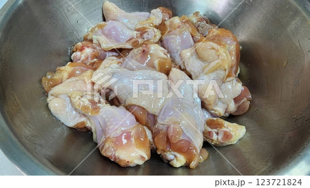 Fresh Chicken Pieces Ready for Cooking in Stainless Steel Bowl 123721824