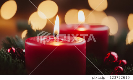 Red candles glowing warmly with pine and ornaments around, bokeh lights in the background. Concept: cozy holiday ambiance. 123722619