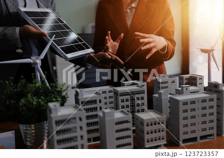 Discussion among businesspeople on the latest developments in solar cell panel technology and Solar Energy Environment city Concept. 123723357
